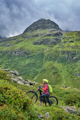 Fototapeta premium nice active senior woman riding her electric mountain bike in the silvretta mountain range near Gaschurn, Tyrol, Austria