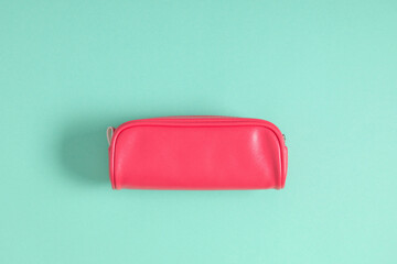 Pink school pencil case on mint background. Back to school. Flat lay, top view, copy space