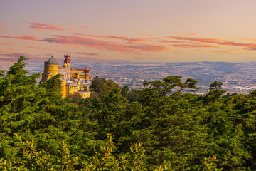 Fototapeta premium Famous historic Pena palace part of cultural site of Sintra against sunset sky in Portugal.