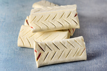 Uncooked Buns with Jam on Blue Background Homemade Bakery Food Pastry Semi-Finished Products Horizontal