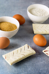 Uncooked Buns with Red Jam on Blue Background Ingredients Sugar Flour Eggs French Pastry Homemade Bakery Breakfast Semi-Finished products Vertical