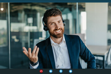 Teleconference concept. Screenshot of happy businessman making video call and gesturing at laptop...
