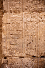 Different hieroglyphs on the walls and columns in the Karnak temple. Karnak temple is the largest complex in ancient Egypt.