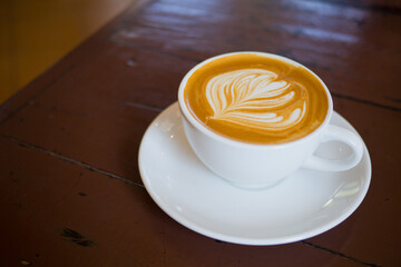 hot latte art coffee on wood table, relax time
