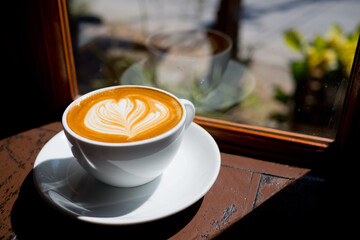 hot latte art coffee on wood table, relax time
