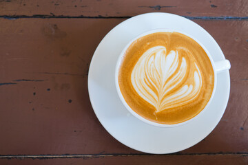 hot latte art coffee on wood table, relax time

