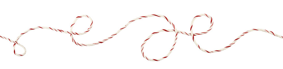 Curled white and red Christmas wrapping rope in a line arrangement isolated on white