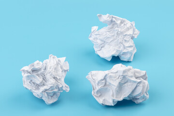 Fototapeta premium A piece of crumpled white paper on a blue background.