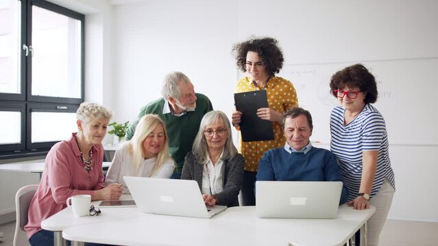 Group of senior people attending computer and technology education class.