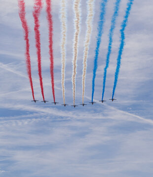Paris, France - 07 17 2022: Air show of July 14. Alphajet of the patrol of France flying above the district of La Defense
