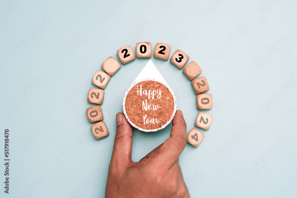 Poster hand turning knob for change year from 2022 to 2023 which print screen on wooden cube block for prep