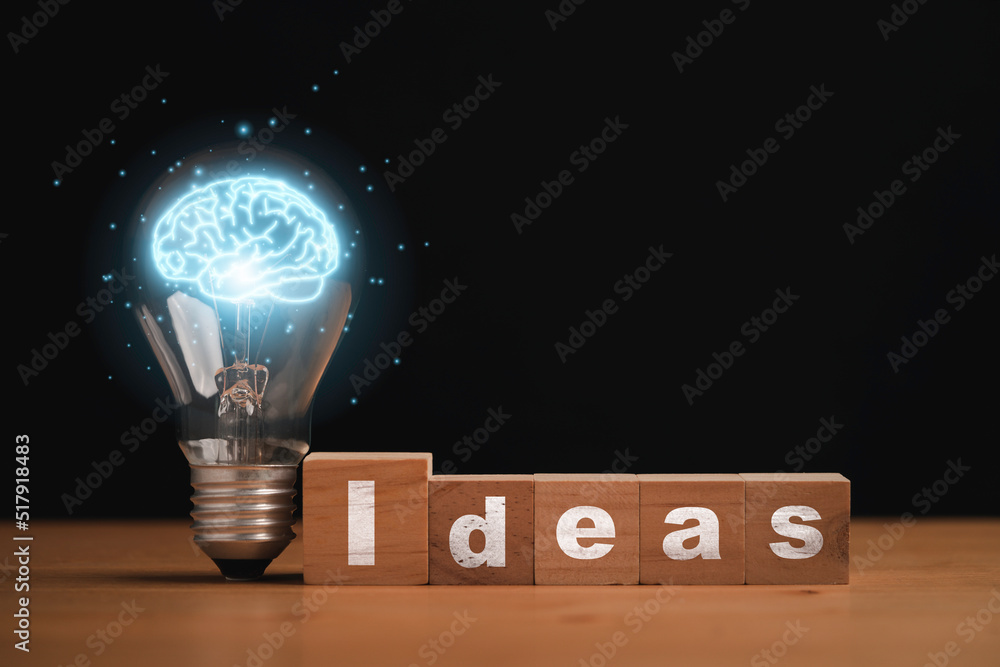 Poster virtual blue brain inside of lightbulb with idea wording on wooden cube block for creative thinking 
