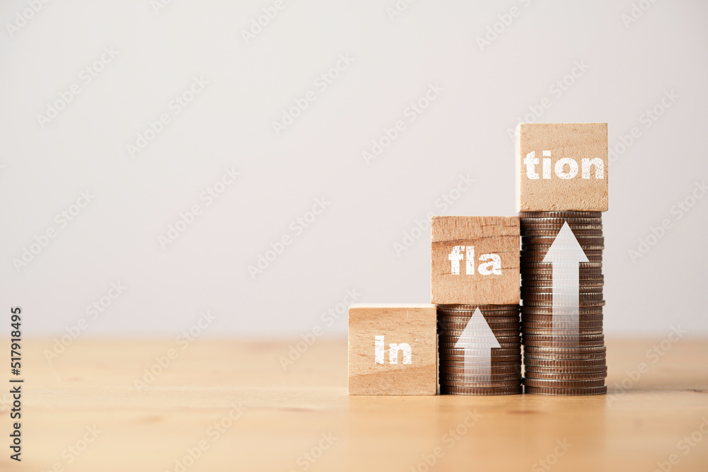 Poster inflation wording print screen on wooden cube block with white up arrow on coins stacking for increa