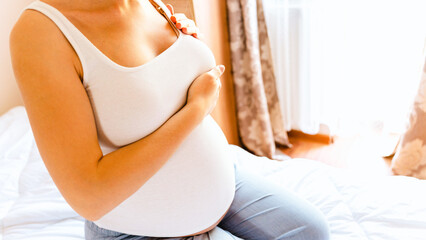 Breast self exam pregnancy woman check. Happy young pregnant woman self exam. Cancer self check....