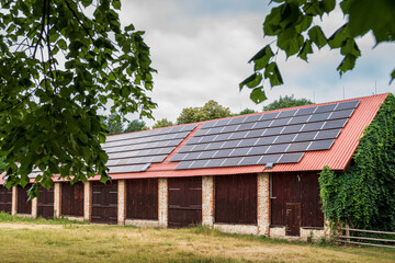 A huge brick barn with solar panels on the roof. Horse stud in Florianka. Beautiful rural landscape