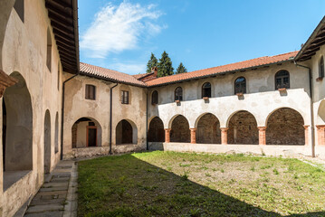Fototapeta na wymiar Courtyard of the Parish Museum of the Abbey of Saint Gemolo in Ganna, Valganna, province of Varese, Italy