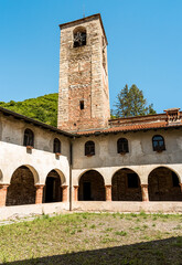 Fototapeta na wymiar Courtyard with Bell Tower of the Parish Museum of the Abbey of Saint Gemolo in Ganna, Valganna, province of Varese, Italy