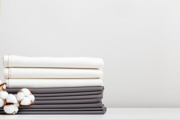 Gray and white bed linen, cotton branch sheets on the table