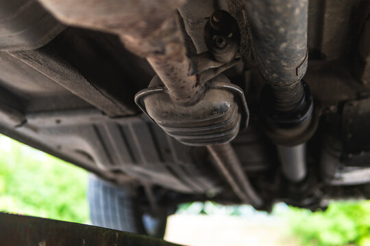 Close-up of Catalytic Converter in Car Exhaust System. The concept of preserving ecology, reducing harmful emissions into the air. legal regulations for vehicles with internal combustion engines