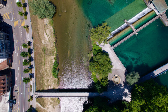 Junction of Limmat River and Sihl River at Platzspitz Park at City of Z&uuml;rich with swimmers and people sunbathing on a sunny summer day. Photo taken June 20th, 2022, Zurich, Switzerland.