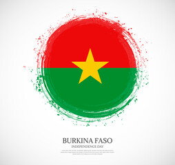 Creative circular grungy shape brush stroke flag of Burkina Faso on a solid background