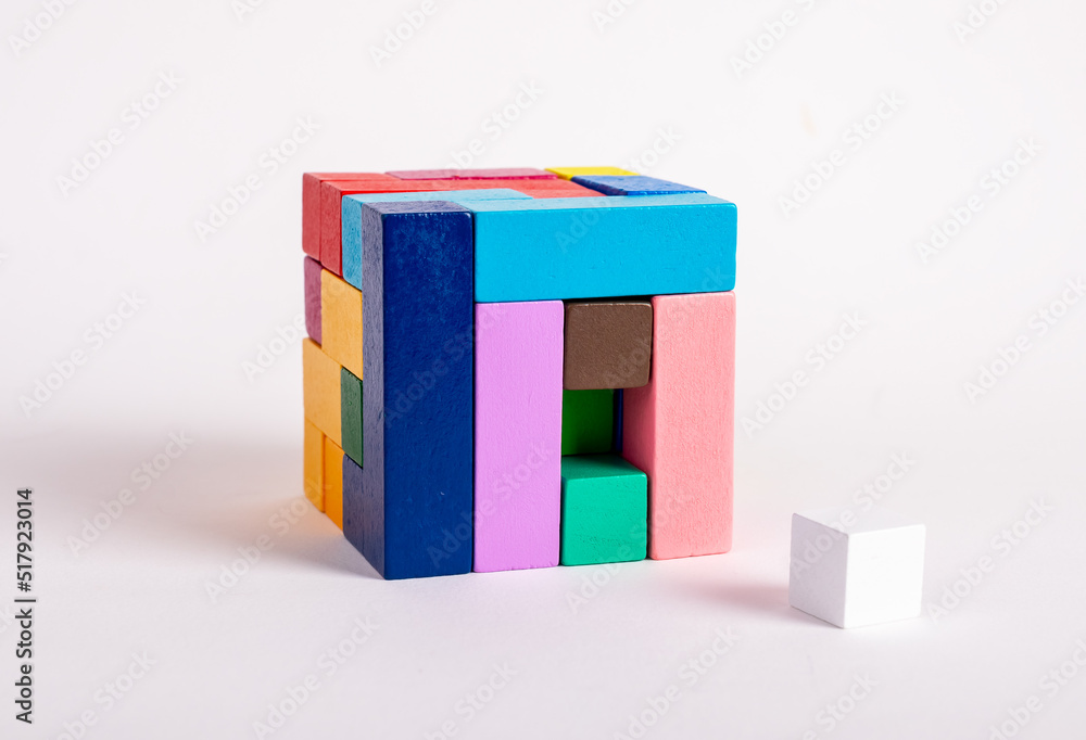Poster wooden cube from multicolored blocks with one missing element. construction last step concept. kids 