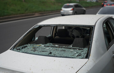 Close up view on a heavily shattered windshield of a car, external. completely broken car...