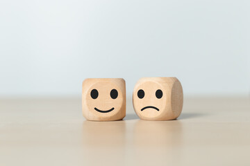 face emotion positive and negative concept. wooden cube with smiley face and sad face icon. satisfaction and service ranking.