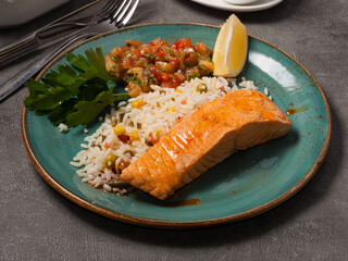 grilled salmon, rice with vegetables and vegetable salad