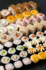 assorted sushi rolls on a gray background