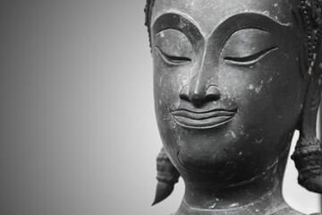 Fototapeta na wymiar The head of an ancient Buddha statue was made of bronze. image on copy space gray background.