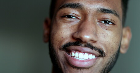 Naklejka premium Friendly black African man looking at camera smiling