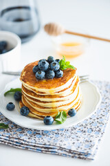 Homemade baked ricotta pancakes with fresh berries on white wooden table
