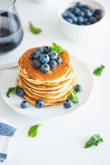 Homemade baked ricotta pancakes with fresh berries on white wooden table