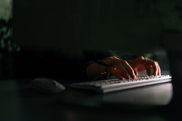 Close-up hands of unrecognizable hacker breaking online web site, engaging hacking into security...