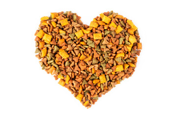 A heart lined with dry cat food on a white isolated background. Balanced nutrition of pets.