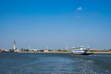 View of the ferry across the Weser to Bremerhaven/Germany with the harbor entrance in the background