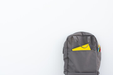 Backpack with different colorful stationery. Back to school