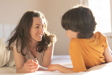 the boy with his mother lies on the bed