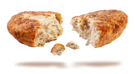 Fried cutlet broken in half flies on a white background.