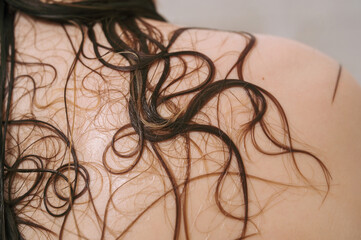 Closeup of female back with wet hair strands
