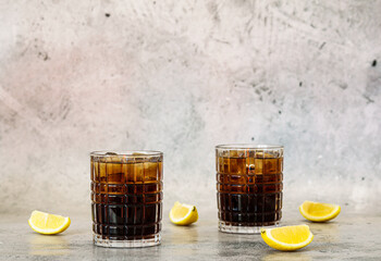 Cooling Long Island iced tea with lemon and ice cubes