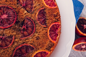 delicious cake with red oranges slices on top