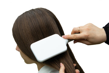 hairdresser combing long blond hair with a white square comb, isolated