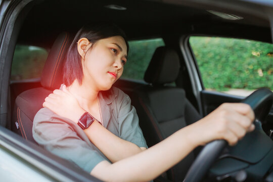 Beautiful Asian woman having pain in arm and shoulder
Beautiful Asian woman massaging her arm or shoulder long driving on the way