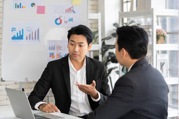 A group of young Asian businessmen Talking and planning work happily and have fun. at the company's office