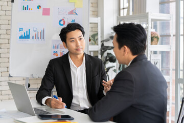A group of young Asian businessmen Talking and planning work happily and have fun. at the company's office