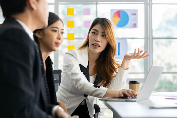 A group of young Asian businessmen Talking and planning work happily and have fun. at the company's office