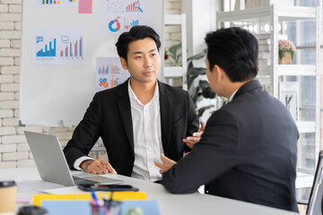 A group of young Asian businessmen Talking and planning work happily and have fun. at the company's office