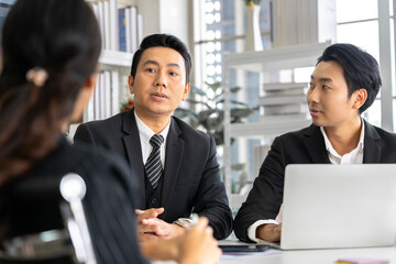 A group of young Asian businessmen Talking and planning work happily and have fun. at the company's office